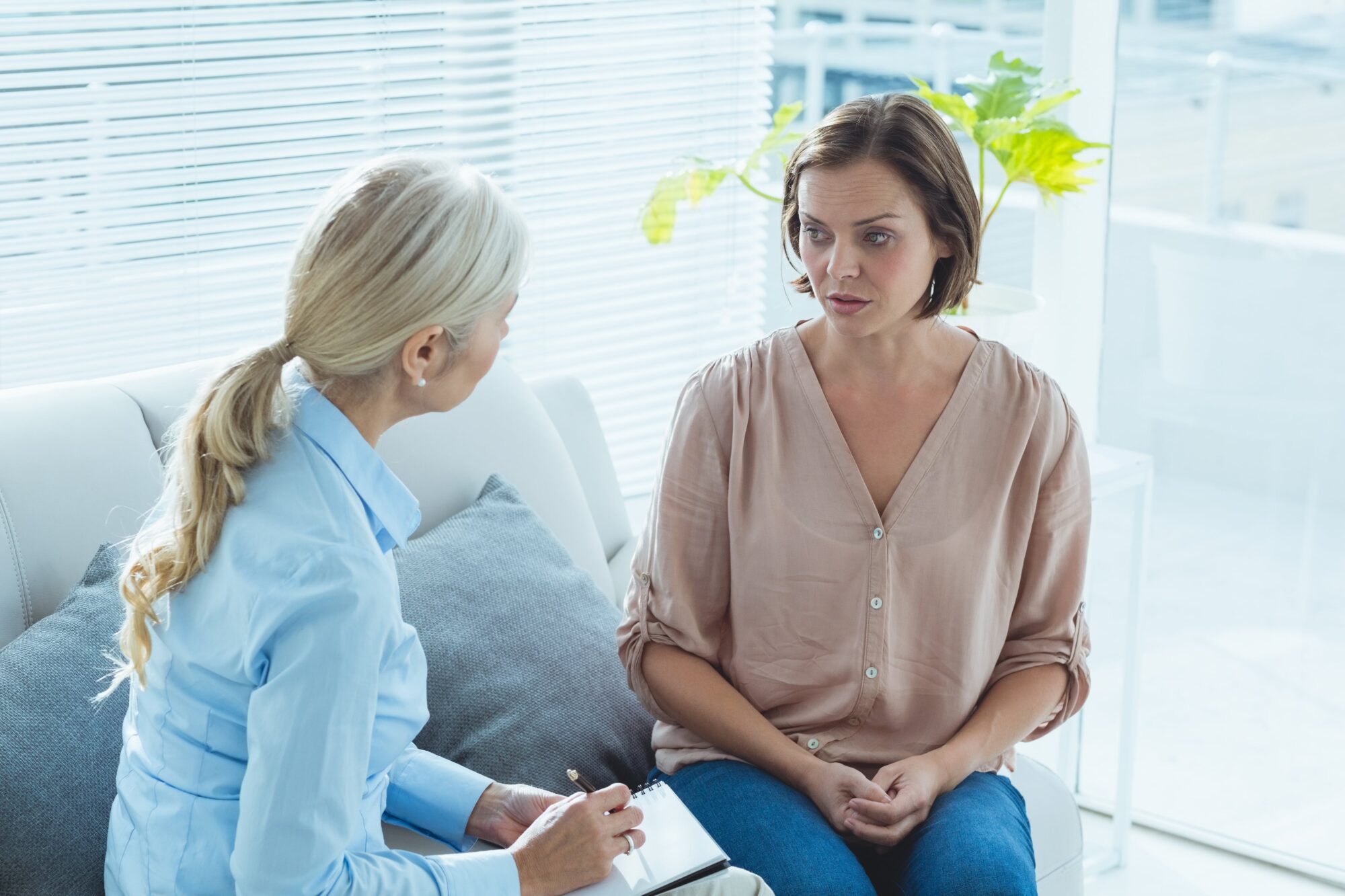 Upset woman talking with counselor